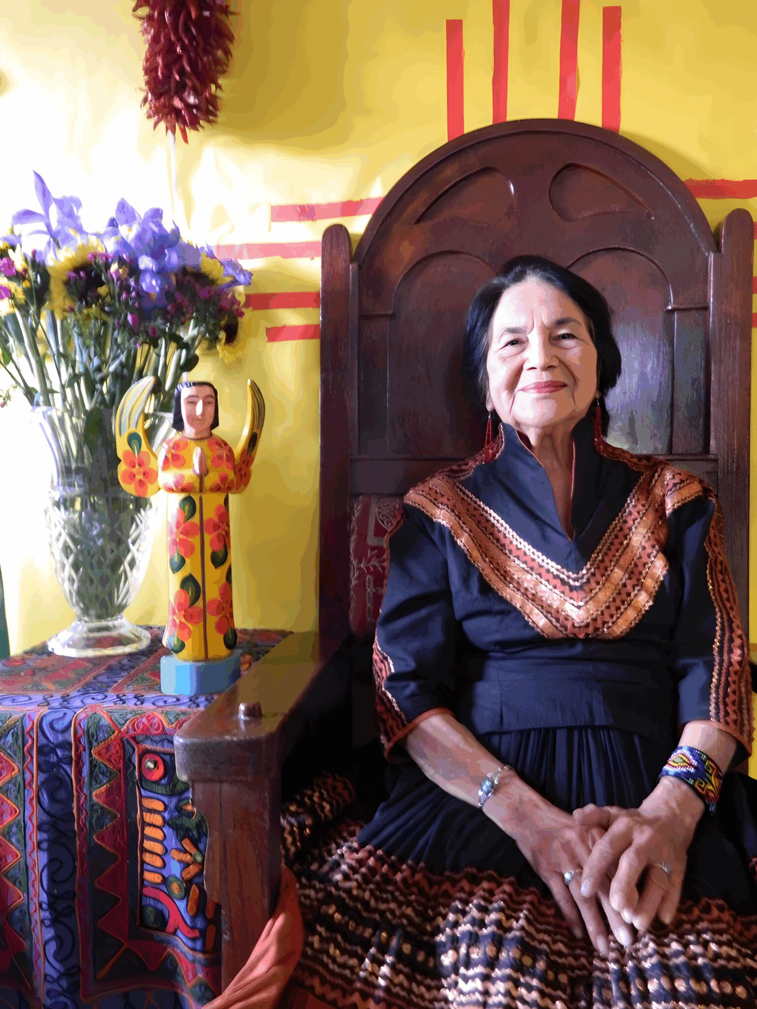 Woman sitting next to colorful decorations.